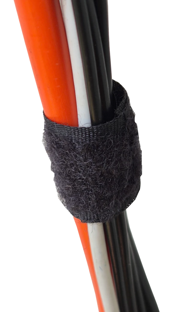 View of one black velcro wire strap holding some cables together.